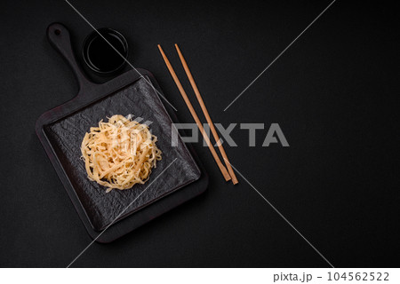Delicious dried squid in the form of shavings with salt and spices Delicious dried squid in the form of shavings with salt and spices 104562522