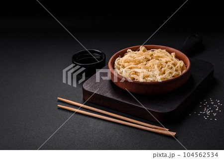 Delicious dried squid in the form of shavings with salt and spices Delicious dried squid in the form of shavings with salt and spices 104562534