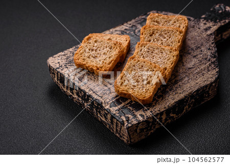 Delicious salted rectangular wheat croutons with salt and spices Delicious salted rectangular wheat croutons with salt and spices 104562577