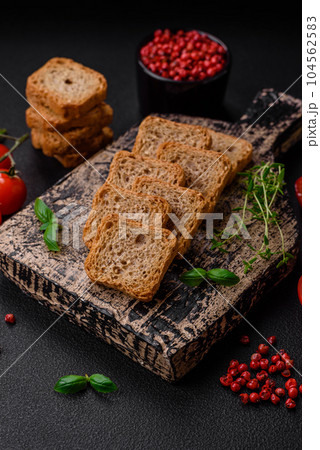 Delicious salted rectangular wheat croutons with salt and spices Delicious salted rectangular wheat croutons with salt and spices 104562583
