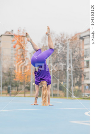 Sport fitness handstand exercise for calisthenics balance. Hispanic mid adult woman workout Sport fitness handstand exercise for calisthenics balance. Hispanic mid adult woman workout 104563120