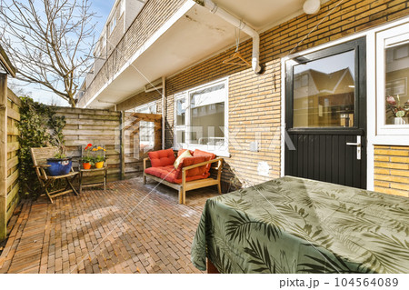 an outside area with a bed, couch and table in the fore - image is taken from another room on the other side an outside area with a bed, couch and table in the fore - image is taken from another room on the other side 104564089