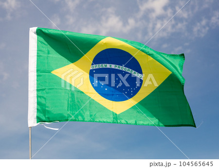 Brazil flag waving against blue sky Brazil flag waving against blue sky 104565645