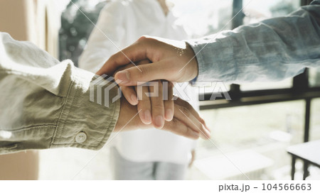 Group of corporate colleagues united, joining or working together. 104566663