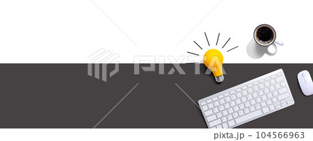 Computer keyboard with a yellow light bulb Computer keyboard with a yellow light bulb 104566963
