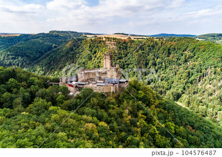 aerial view rock with medieval castle Ehrenburg on it near moselle river in Brodenbach with forest hills 104576487