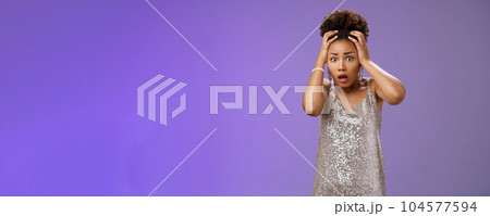 Shocked speechless gasping african-american woman grab head cannot look what happening standing shook worried, anxious friend break fragile vase in glittering silver dress nervously Shocked speechless gasping african-american woman grab head cannot look what happening standing shook worried, anxious friend break fragile vase in glittering silver dress nervously 104577594