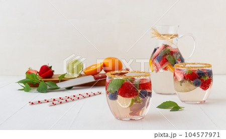 Homemade lemonade with fresh summer fruits. Homemade lemonade with fresh summer fruits. 104577971
