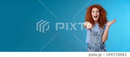Excited impressed surprised cute redhead european woman curly astonished happily pointing index finger camera gesturing lively thrilled see awesome thing reacting amazed standing blue background Excited impressed surprised cute redhead european woman curly astonished happily pointing index finger camera gesturing lively thrilled see awesome thing reacting amazed standing blue background 104578061