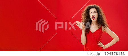 Stop talking you making me sick. Displeased and arrogant picky dark-haired woman with curly hairstyle saying blah-blah turning away from annoying person rolling eyes up and frowning from aversion 104578138