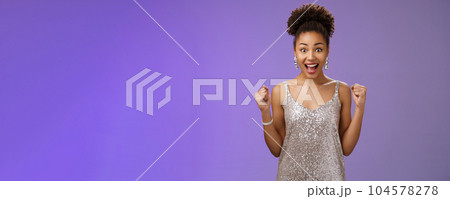 Impressed surprised thrilled joyful charming elegant african-american woman winning money casino achieve success yelling happily raise fists victory triumph gesture cheering gladly blue background Impressed surprised thrilled joyful charming elegant african-american woman winning money casino achieve success yelling happily raise fists victory triumph gesture cheering gladly blue background 104578278