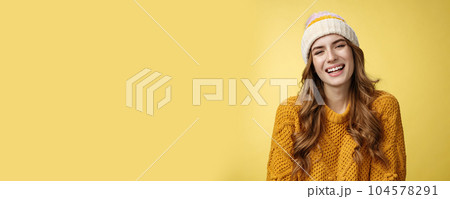 Close-up flirty coquettish good-looking happy smiling woman laughing having fun enjoying interesting funny conversation grinning joyfully wearing warm cozy corduroy hat, knitted sweater 104578291
