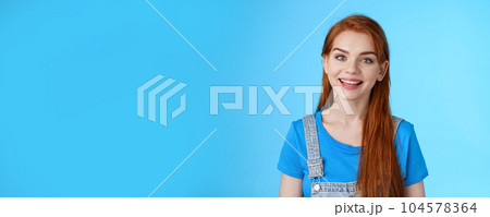 Friendly confident pleasant redhead woman helpfully look camera, smiling joyfully, have conversation customer, give advice, stand upbeat good positive mood blue background, grin amused Friendly confident pleasant redhead woman helpfully look camera, smiling joyfully, have conversation customer, give advice, stand upbeat good positive mood blue background, grin amused 104578364