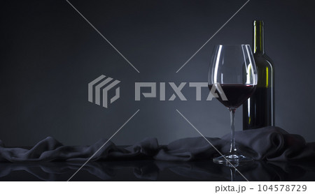 Glass and bottle of red wine. 104578729