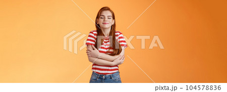 Tender lovely redhead modern woman embrace own body, feel happiness self-acceptance, smiling close eyes, cross arms, hugging herself dreamy, imaging something, daydreaming orange background Tender lovely redhead modern woman embrace own body, feel happiness self-acceptance, smiling close eyes, cross arms, hugging herself dreamy, imaging something, daydreaming orange background 104578836