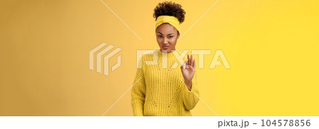 Okay not bad. Portrait devious serious-looking confident african-american bossy girl check out nice work done show ok gesture smug approval agree like good job, standing yellow background pleased 104578856