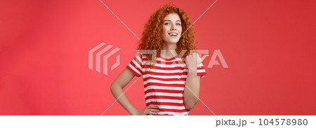 Accomplished good-looking redhead curly woman raise head proudly confident pointing thumb left smiling camera assertive sharing awesome product location recommend perfect store offer Accomplished good-looking redhead curly woman raise head proudly confident pointing thumb left smiling camera assertive sharing awesome product location recommend perfect store offer 104578980