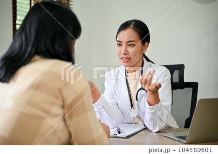 Young female doctor diagnose female patient in her clinic room. 104580601