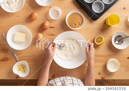Girl is cooking muffins in the kitchen process concept ingredients simple 104581558