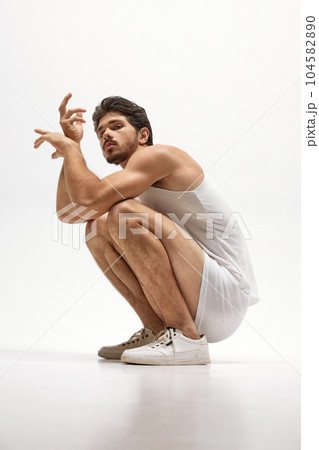Portrait of handsome young dark-haired man posing isolated over studio background. Male natural beauty concept. 104582890