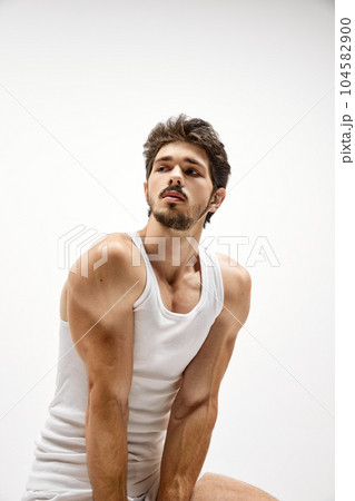 Muscular male fashion model wearing cotton underwear posing isolated over white background. Concept of men's health, beauty, fitness, fashion. Muscular male fashion model wearing cotton underwear posing isolated over white background. Concept of men's health, beauty, fitness, fashion. 104582900