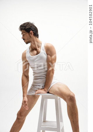 Young handsome Caucasian man wearing homewear posing over white studio background. Concept of men's health, beauty of male body, fashion, ad 104582901