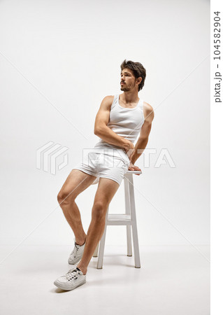Portrait of handsome young dark-haired man posing isolated over studio background. Male natural beauty concept. Portrait of handsome young dark-haired man posing isolated over studio background. Male natural beauty concept. 104582904