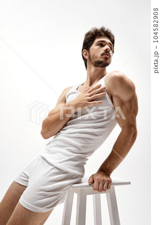 Portrait of handsome young dark-haired man posing isolated over studio background. Male natural beauty concept. 104582908