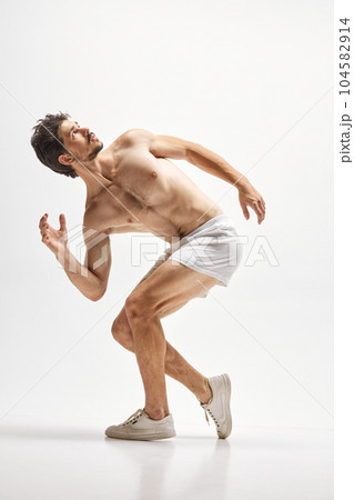 Portrait of handsome young dark-haired man posing isolated over studio background. Male natural beauty concept. Portrait of handsome young dark-haired man posing isolated over studio background. Male natural beauty concept. 104582914