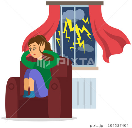 Stressed girl covers ears with hands sitting at home while it rains outside window with thunderstorm 104587404