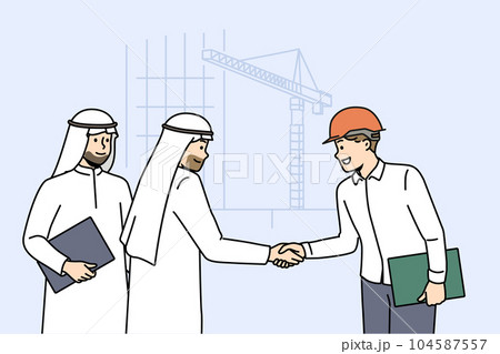 Handshake of arab businessmen and builder from architectural bureau standing near tower crane 104587557