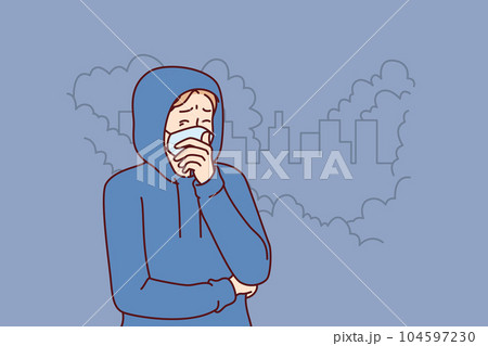 Man suffers from emissions from industrial factory and wears mask to protect against toxic smoke 104597230