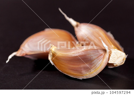 White garlic isolated on black background. Vegetable White garlic isolated on black background. Vegetable 104597294