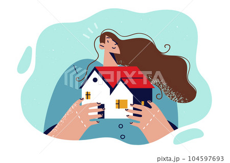 Woman broker holds model of house in hands, offering to take out mortgage to buy cottage. 104597693
