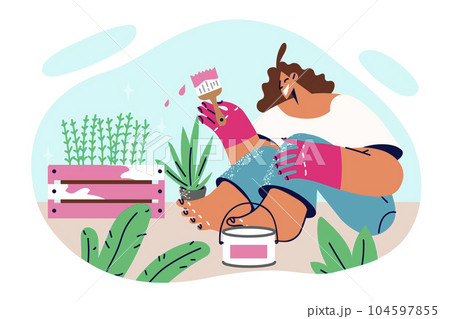 Woman painting garden furniture with plants sitting on ground and making decorations for backyard 104597855