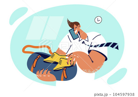 Busy man puts shoes in bag for going on business trip and talks on phone discussing travel plan Busy man puts shoes in bag for going on business trip and talks on phone discussing travel plan 104597938