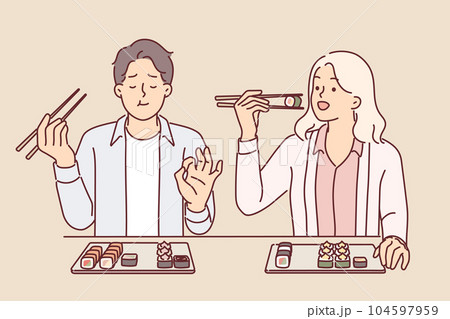 Couple eats sushi at japanese restaurant enjoying maki rolls with fresh fish and rice Couple eats sushi at japanese restaurant enjoying maki rolls with fresh fish and rice 104597959