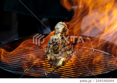 Grill steak tomahawk. Angus beef tbone on fire flame 104598844