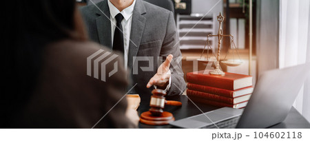 Business people and lawyers discussing contract papers sitting in the table at office in the morning. concepts of law, advice, legal services. Business people and lawyers discussing contract papers sitting in the table at office in the morning. concepts of law, advice, legal services. 104602118