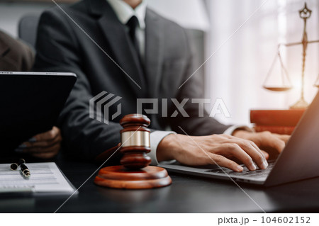 Lawyer office. gavel of Justice with scales and lawyer working on a laptop. Legal law, advice and justice concept. 104602152