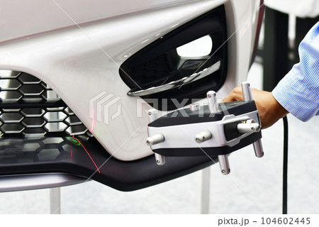 Hand-held 3D laser scanners measure the accuracy of automotive parts. in industrial plants, copy space Hand-held 3D laser scanners measure the accuracy of automotive parts. in industrial plants, copy space 104602445