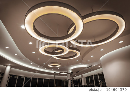 Hanging rounded ceiling mounted light fixtures with modern LED light bulb. 104604579