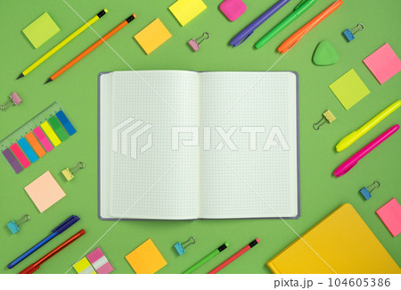 Open notebook with space for your text with colorful school and office supplies Open notebook with space for your text with colorful school and office supplies 104605386