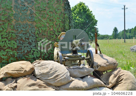 Maxim machine gun from the First World War with a machine gunner. Maxim machine gun from the First World War with a machine gunner. 104606228