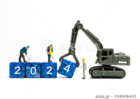 Miniature people , Worker team flips a block with the number 2024 Miniature people , Worker team flips a block with the number 2024 104606441
