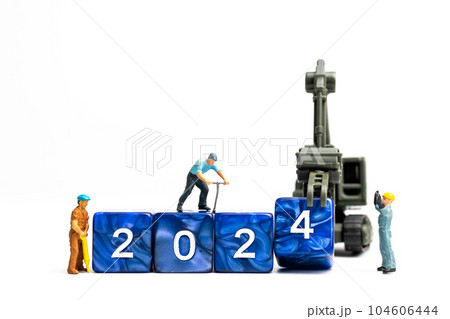Miniature people , Worker team flips a block with the number 2024 Miniature people , Worker team flips a block with the number 2024 104606444