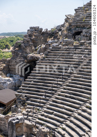 Side Ancient theatre. Turkey. Antalya. Ruins of the ancient city of Side. The largest amphitheater in Turkey. Main street of the ancient city. Mediterranean Sea. 104608324