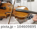 Real life young music students during rehearsals. Musical instruments and music stand with stave. 104609895