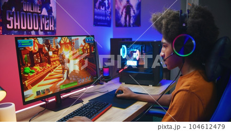 African American gamer plays on PC at home 104612479