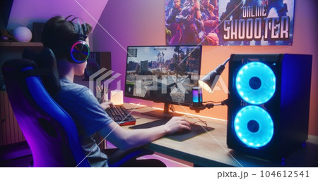 Young gamer controls tank while playing game on PC Young gamer controls tank while playing game on PC 104612541